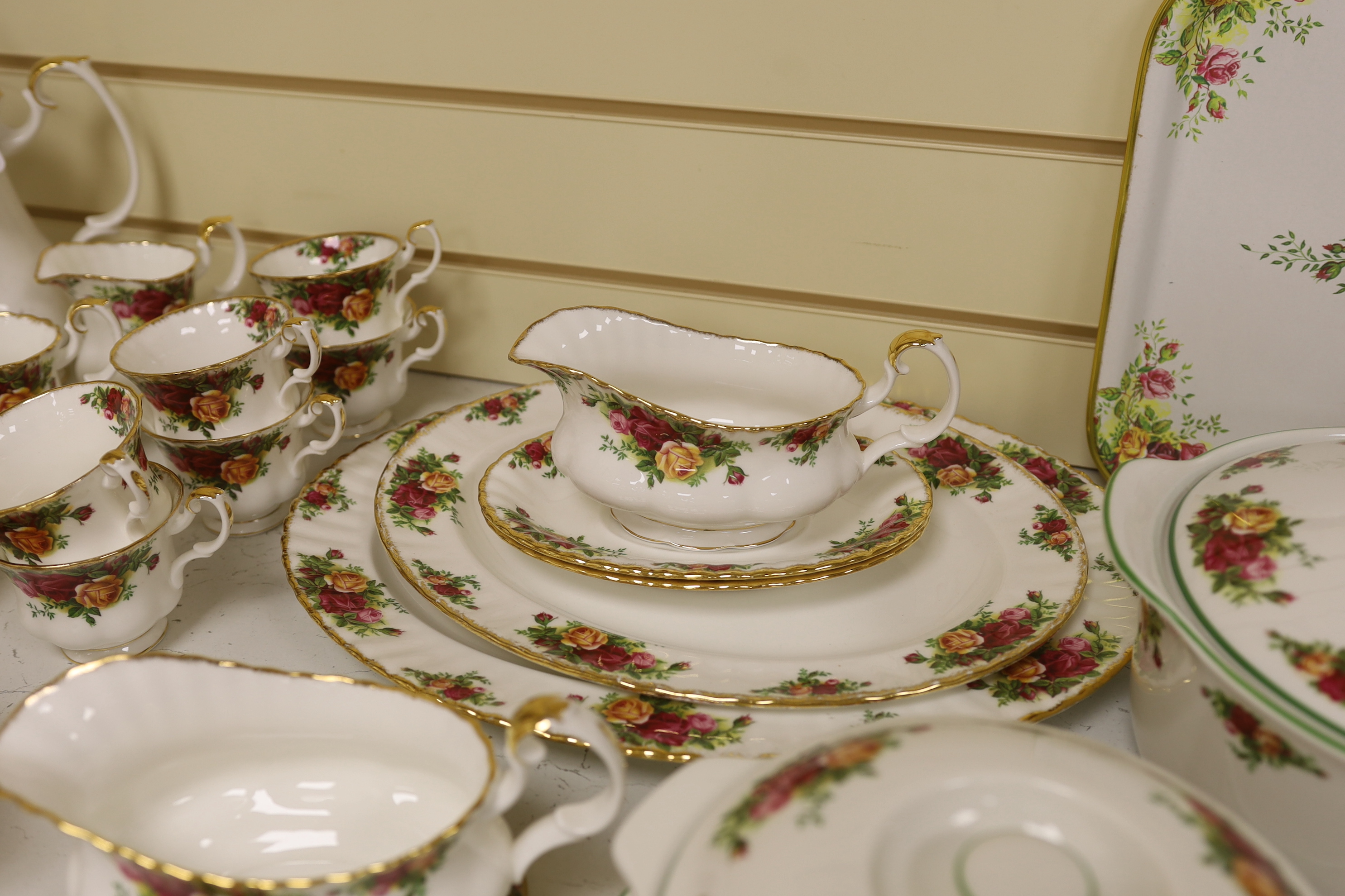 Royal Albert Old Country Roses, a large bone china service for twelve-place setting, and related accessories telephone, wall clock, table mats, napkins and cutlery.